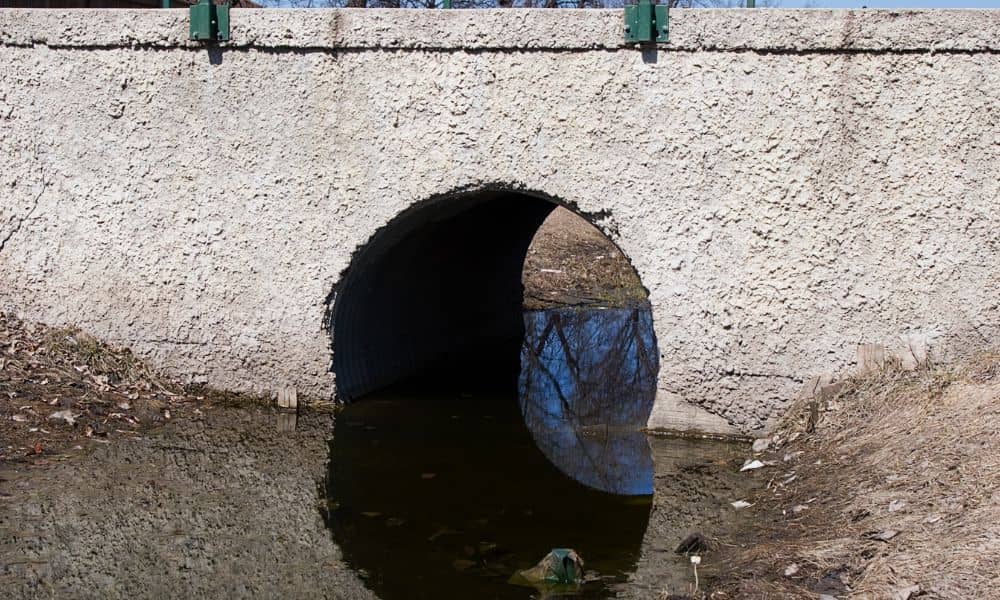 Concrete culvert headwall structure at drainage channel crossing